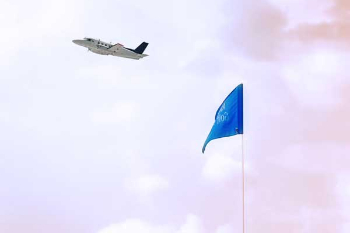 small plane flying over a blue flag at Augusta Municipal Golf Course